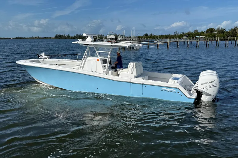  Yacht Photos Pics 2021 Invincible 36 CC boat on water, featuring sleek design and powerful Mercury engines.
