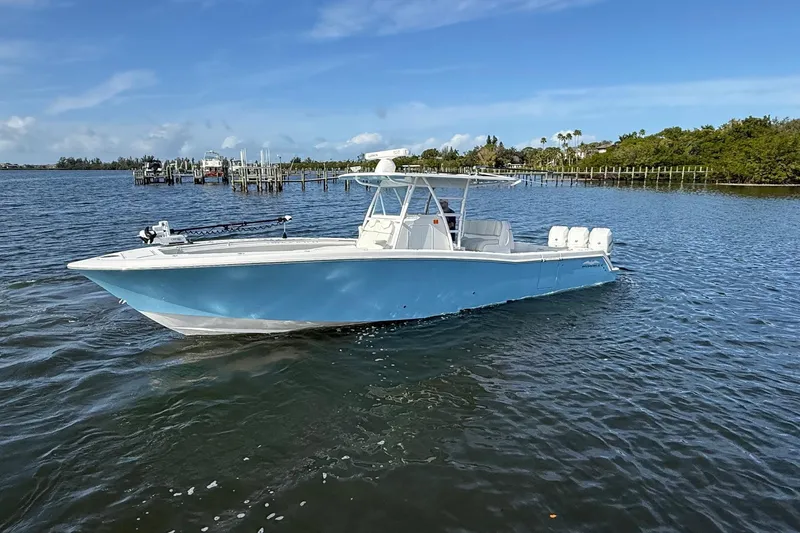  Yacht Photos Pics 2021 Invincible 36 CC boat on calm water, clear sky background.