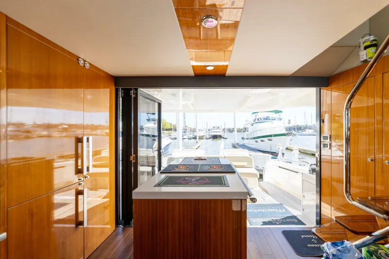 Southern Belle Yacht Photos Pics Interior of 2017 Maritimo M59 yacht with wooden finishes and marina view.