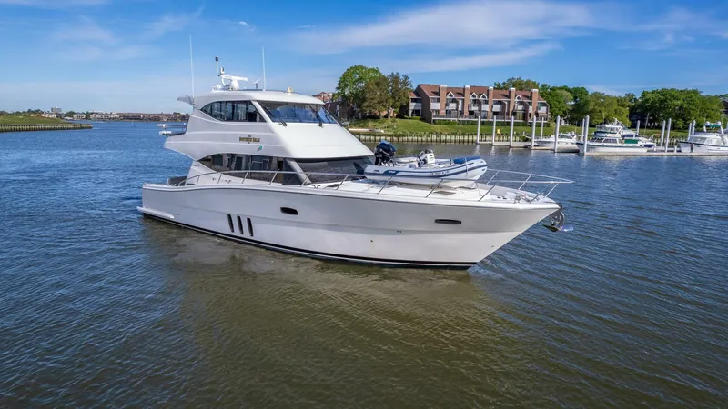 Southern Belle Yacht Photos Pics 2017 Maritimo M59 yacht cruising on a serene river with clear blue skies.