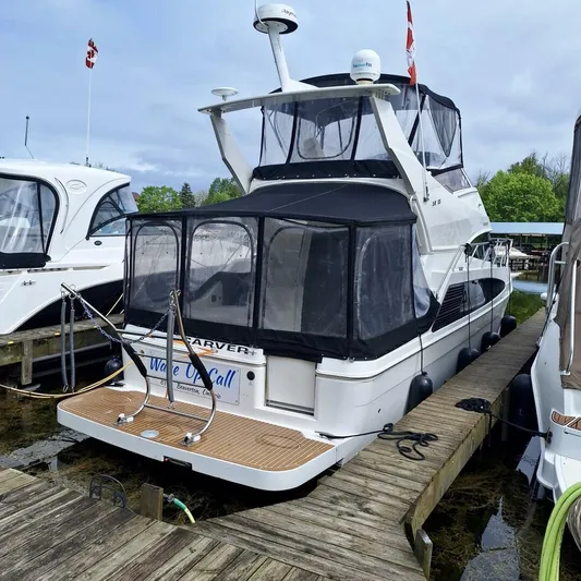  Yacht Photos Pics 2005 Carver 38 Super Sport yacht docked at marina with Canadian flags.