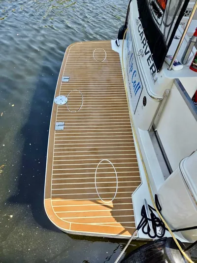  Yacht Photos Pics 2005 Carver 38 Super Sport boat with wooden deck, docked on calm water.