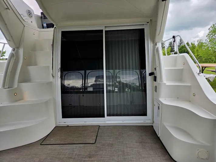  Yacht Photos Pics 2005 Carver 38 Super Sport yacht interior with sliding glass door and dual staircases.