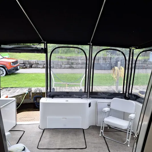  Yacht Photos Pics Interior view of 2005 Carver 38 Super Sport boat with seating and outdoor scenery.