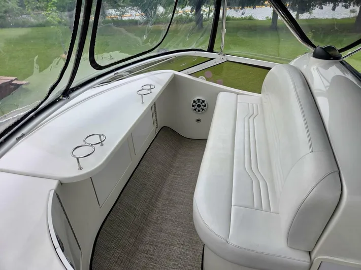  Yacht Photos Pics 2005 Carver 38 Super Sport interior with white seating and cup holders.