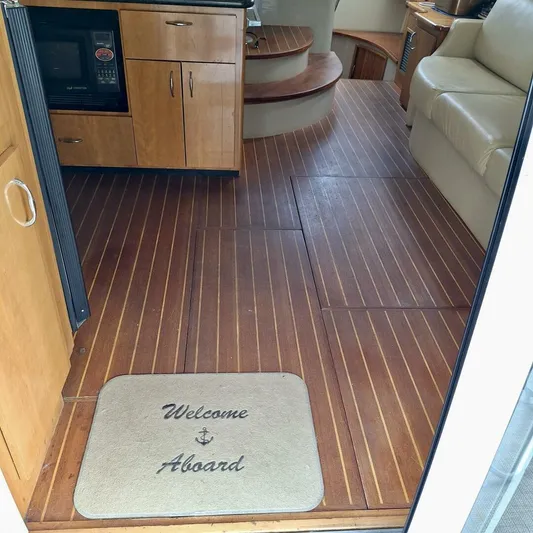  Yacht Photos Pics Interior of 2005 Carver 38 Super Sport yacht with wooden flooring and welcome mat.