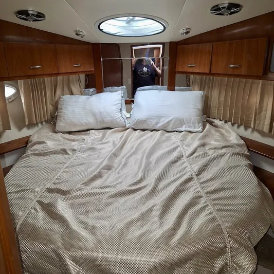  Yacht Photos Pics Cozy bedroom interior of 2005 Carver 38 Super Sport yacht with plush bedding and wood cabinets.