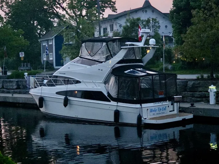  Yacht Photos Pics 2005 Carver 38 Super Sport yacht docked at a serene marina.