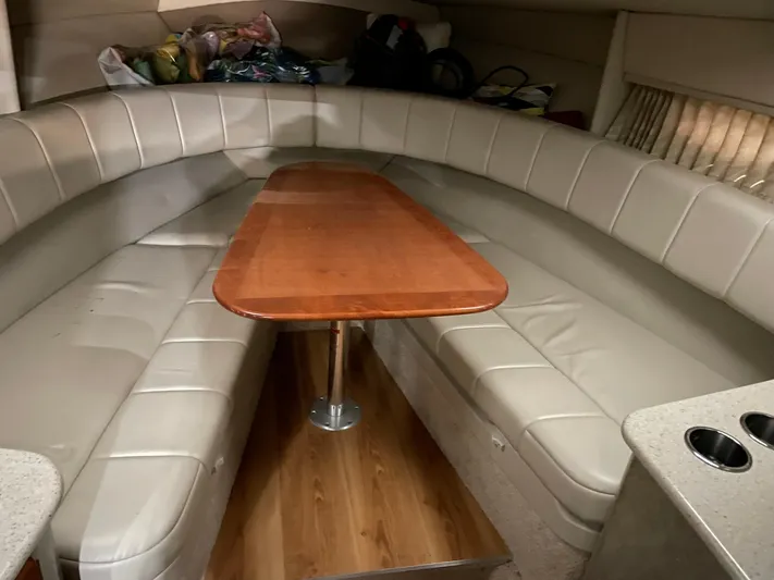 "abe Froman" Yacht Photos Pics 2006 Formula 330 Sun Sport interior with beige seating and wooden table.
