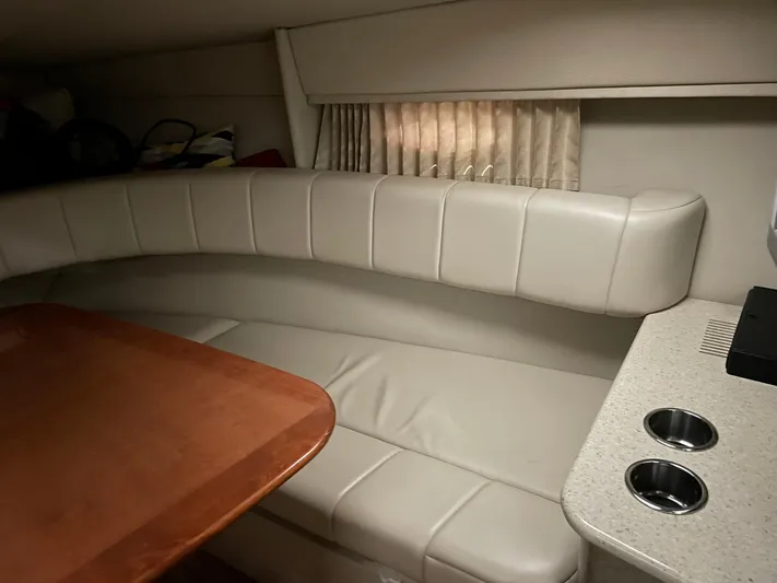 "abe Froman" Yacht Photos Pics 2006 Formula 330 Sun Sport cabin interior with beige seating and wooden table.