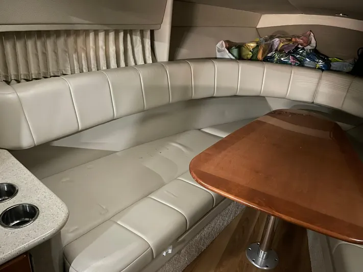 "abe Froman" Yacht Photos Pics 2006 Formula 330 Sun Sport cabin with beige seating and wooden table.