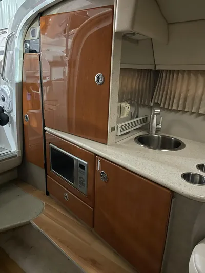 "abe Froman" Yacht Photos Pics 2006 Formula 330 Sun Sport boat interior with kitchenette, microwave, and sink.