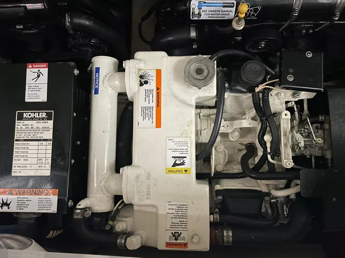 "abe Froman" Yacht Photos Pics Engine compartment of a 2006 Formula 330 Sun Sport boat, featuring a Kohler generator.
