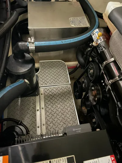 "abe Froman" Yacht Photos Pics Engine compartment of 2006 Formula 330 Sun Sport boat with visible components and hoses.