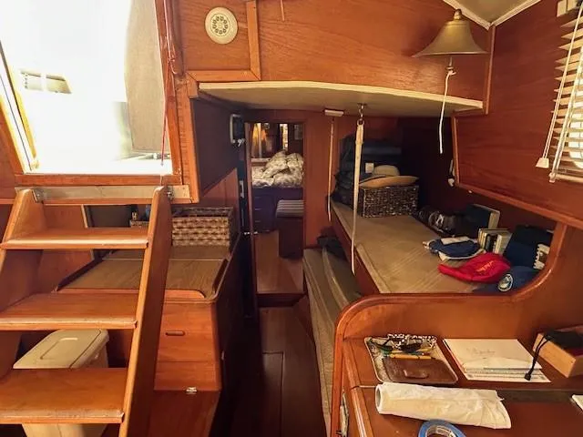 Equinox Yacht Photos Pics Interior of 1980 Irwin 46 Ketch sailboat, featuring wooden furnishings and cozy sleeping area.