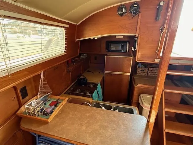 Equinox Yacht Photos Pics 1980 Irwin 46 Ketch interior with wood finish, kitchenette, and nautical decor.
