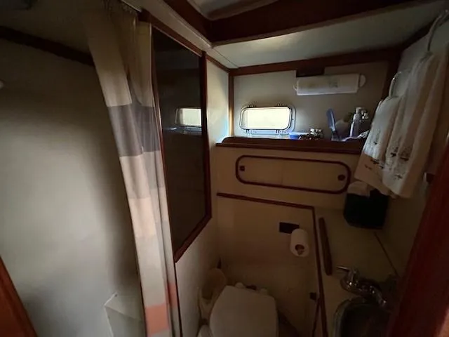 Equinox Yacht Photos Pics 1980 Irwin 46 Ketch bathroom with shower, sink, and porthole window.