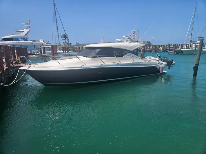  Yacht Photos Pics 2022 Tiara Yachts C39 Coupe docked in a marina with clear blue water.