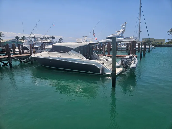  Yacht Photos Pics 2022 Tiara Yachts C39 Coupe docked in a sunny marina.