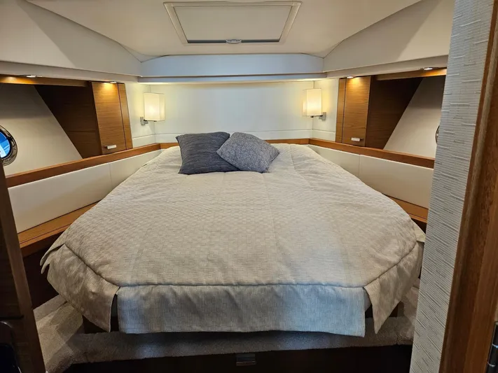  Yacht Photos Pics Luxurious bedroom interior of 2022 Tiara Yachts C39 Coupe with elegant bedding and ambient lighting.