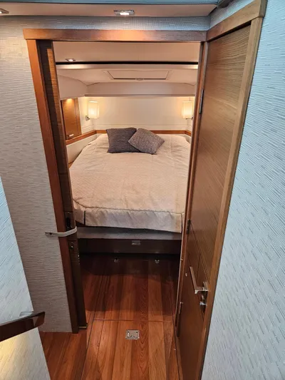  Yacht Photos Pics 2022 Tiara Yachts C39 Coupe cabin with cozy bed and wooden interior.