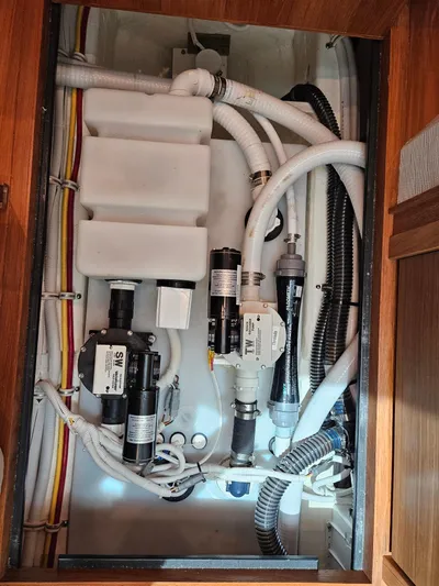  Yacht Photos Pics Engine compartment of a 2022 Tiara Yachts C39 Coupe, showcasing intricate plumbing and wiring.