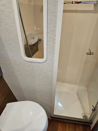  Yacht Photos Pics 2022 Tiara Yachts C39 Coupe bathroom with shower and toilet, featuring modern design.