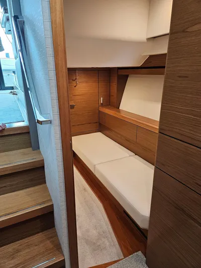  Yacht Photos Pics 2022 Tiara Yachts C39 Coupe interior cabin with wooden finish and cozy seating.