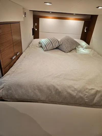  Yacht Photos Pics 2022 Tiara Yachts C39 Coupe cabin with cozy bed and modern wood accents.