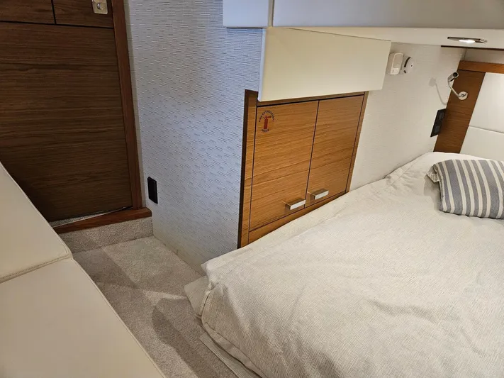  Yacht Photos Pics 2022 Tiara Yachts C39 Coupe interior cabin with bed and wooden cabinetry.