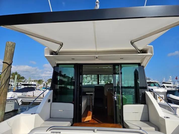  Yacht Photos Pics 2022 Tiara Yachts C39 Coupe at marina, showcasing sleek design and spacious interior.