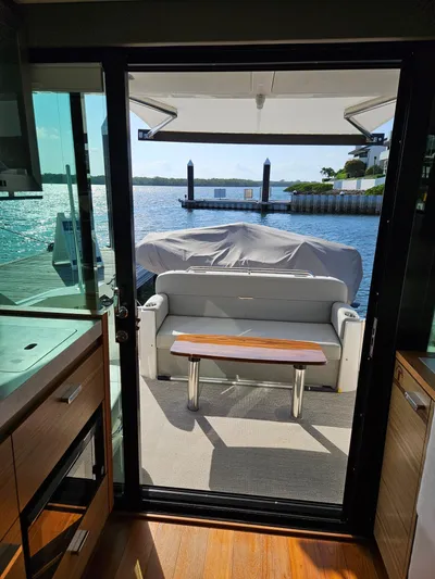  Yacht Photos Pics 2022 Tiara Yachts C39 Coupe interior view with waterfront backdrop.