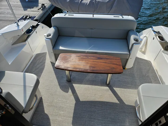  Yacht Photos Pics 2022 Tiara Yachts C39 Coupe interior with seating and wooden table, dockside view.