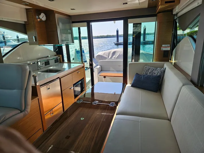  Yacht Photos Pics Interior of 2022 Tiara Yachts C39 Coupe with modern kitchen and seating area.