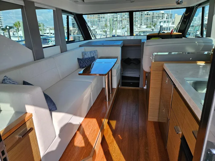  Yacht Photos Pics 2022 Tiara Yachts C39 Coupe interior with modern seating and wooden flooring.