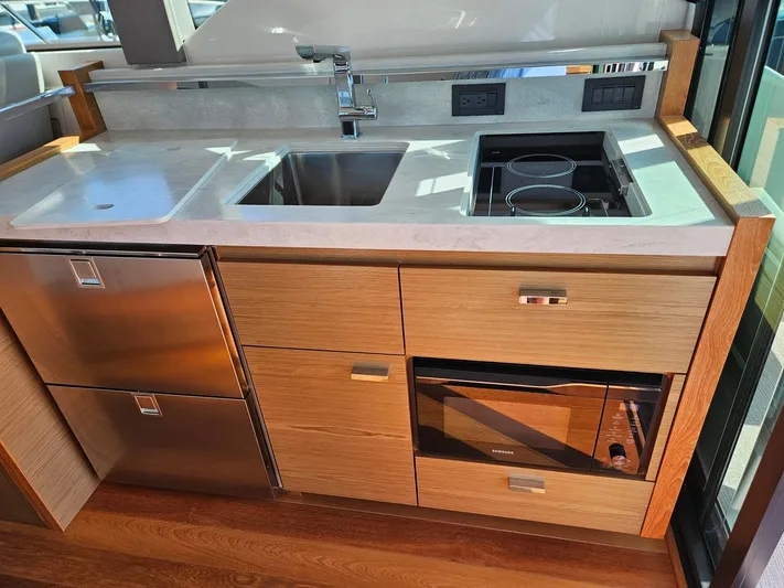  Yacht Photos Pics Modern kitchen in 2022 Tiara Yachts C39 Coupe with sink, stove, and storage.