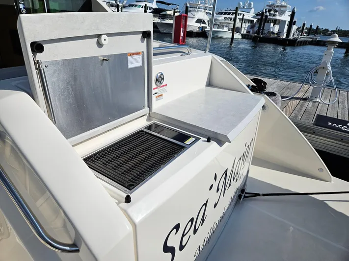  Yacht Photos Pics 2022 Tiara Yachts C39 Coupe with open grill on deck, docked at marina.