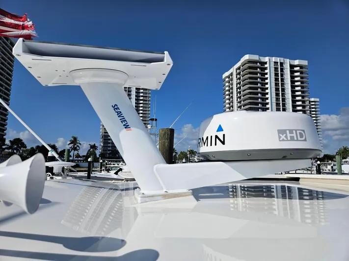  Yacht Photos Pics 2022 Tiara Yachts C39 Coupe with Garmin xHD radar, docked near high-rise buildings.