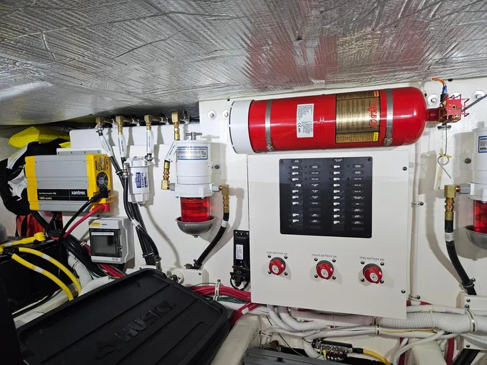  Yacht Photos Pics Engine room of 2022 Tiara Yachts C39 Coupe with fire extinguisher and control panel.