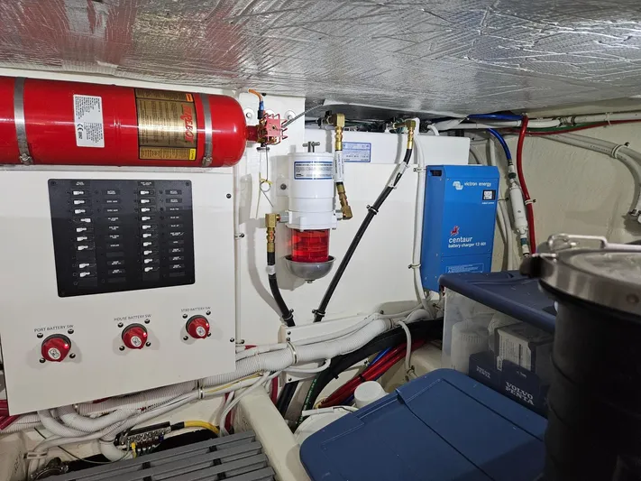  Yacht Photos Pics Engine room of 2022 Tiara Yachts C39 Coupe with fire extinguisher and control panel.
