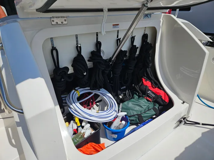 Yacht Photos Pics Open storage compartment on 2022 Tiara Yachts C39 Coupe with ropes and cleaning supplies.