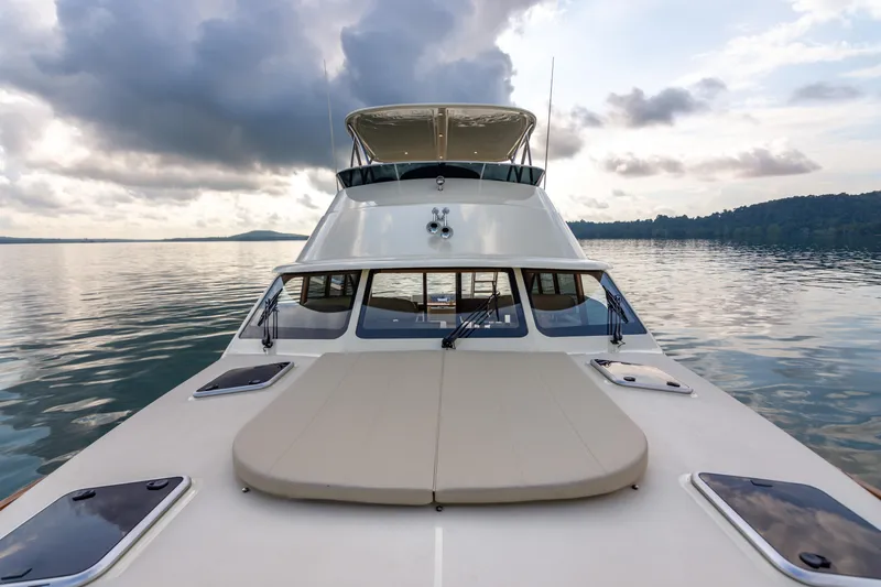 Independence Yacht Photos Pics 2021 Palm Beach Motor Yachts PB65 on calm water under cloudy sky.