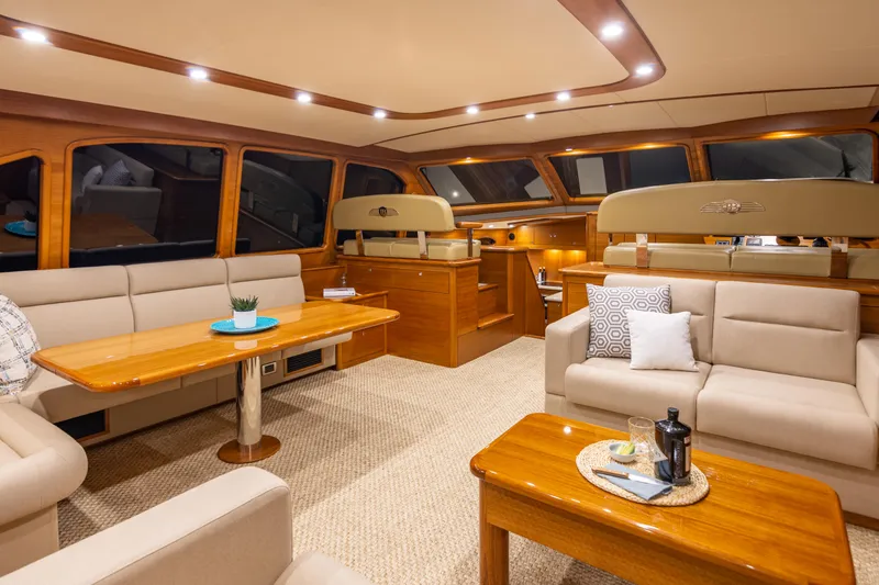 Independence Yacht Photos Pics Luxurious interior of 2021 Palm Beach Motor Yachts PB65 with elegant seating and wooden accents.