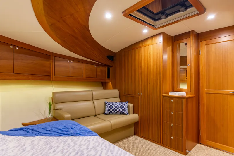 Independence Yacht Photos Pics Luxurious 2021 Palm Beach Motor Yachts PB65 interior with elegant wood finish and cozy seating.