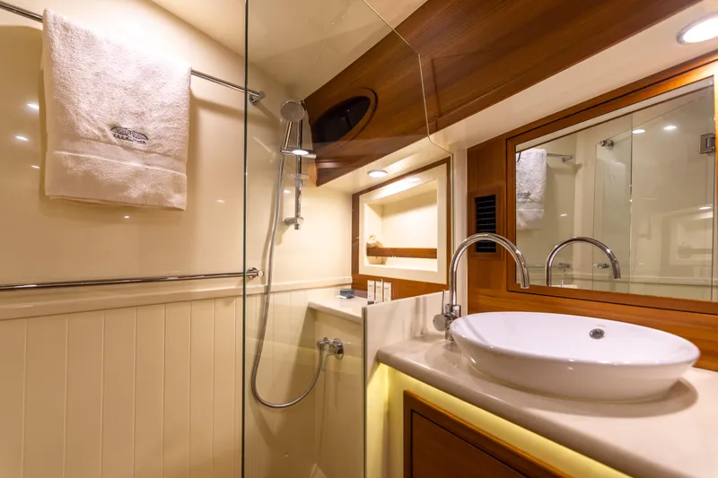 Independence Yacht Photos Pics Luxurious bathroom in 2021 Palm Beach Motor Yachts PB65, featuring modern fixtures and elegant design.