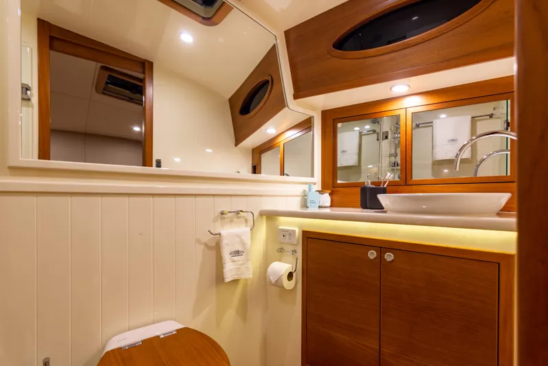 Independence Yacht Photos Pics Luxurious bathroom in 2021 Palm Beach Motor Yachts PB65, featuring elegant wood accents.