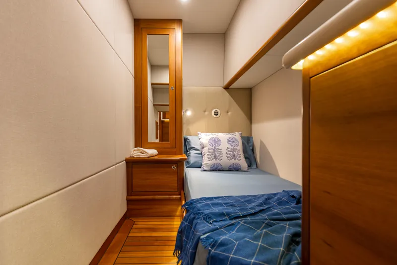 Independence Yacht Photos Pics Luxurious cabin interior of 2021 Palm Beach Motor Yachts PB65 with elegant wood finishes.