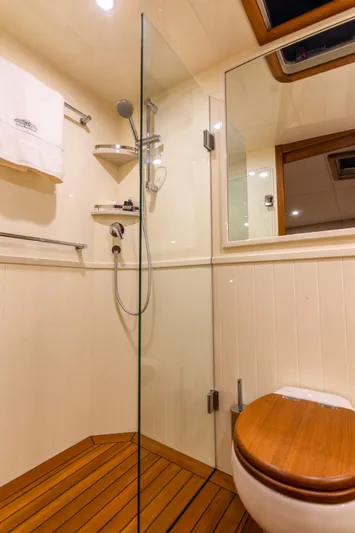 Independence Yacht Photos Pics Luxurious bathroom in 2021 Palm Beach Motor Yachts PB65, featuring wood accents and modern fixtures.