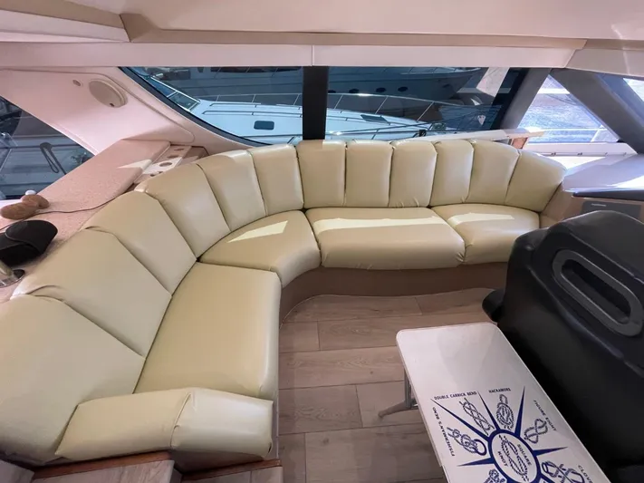 Relentless Yacht Photos Pics Luxurious interior of 1998 Carver 530 Voyager Pilothouse with cream leather seating.