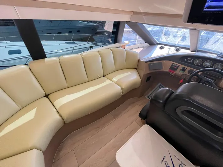 Relentless Yacht Photos Pics Interior of 1998 Carver 530 Voyager Pilothouse with beige seating and helm controls.